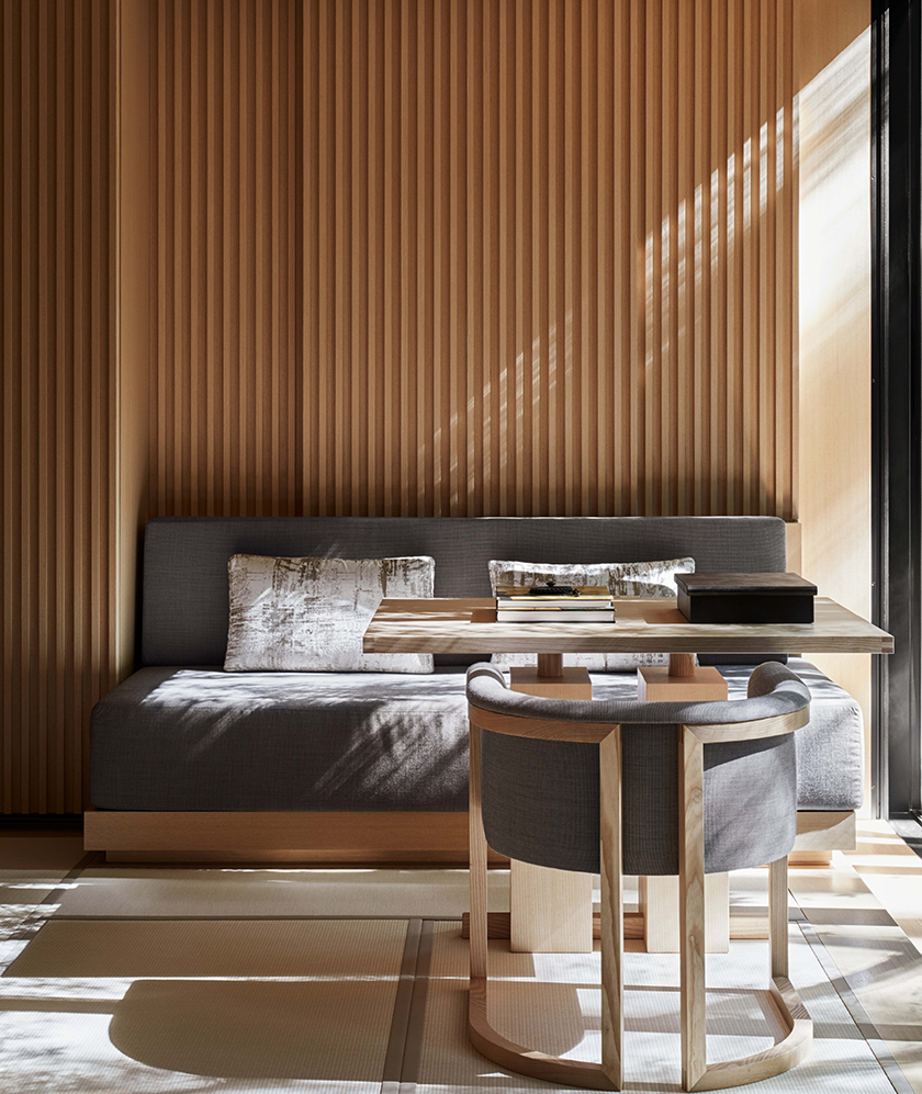 Afternoon light across the slatted timber wall of a suite