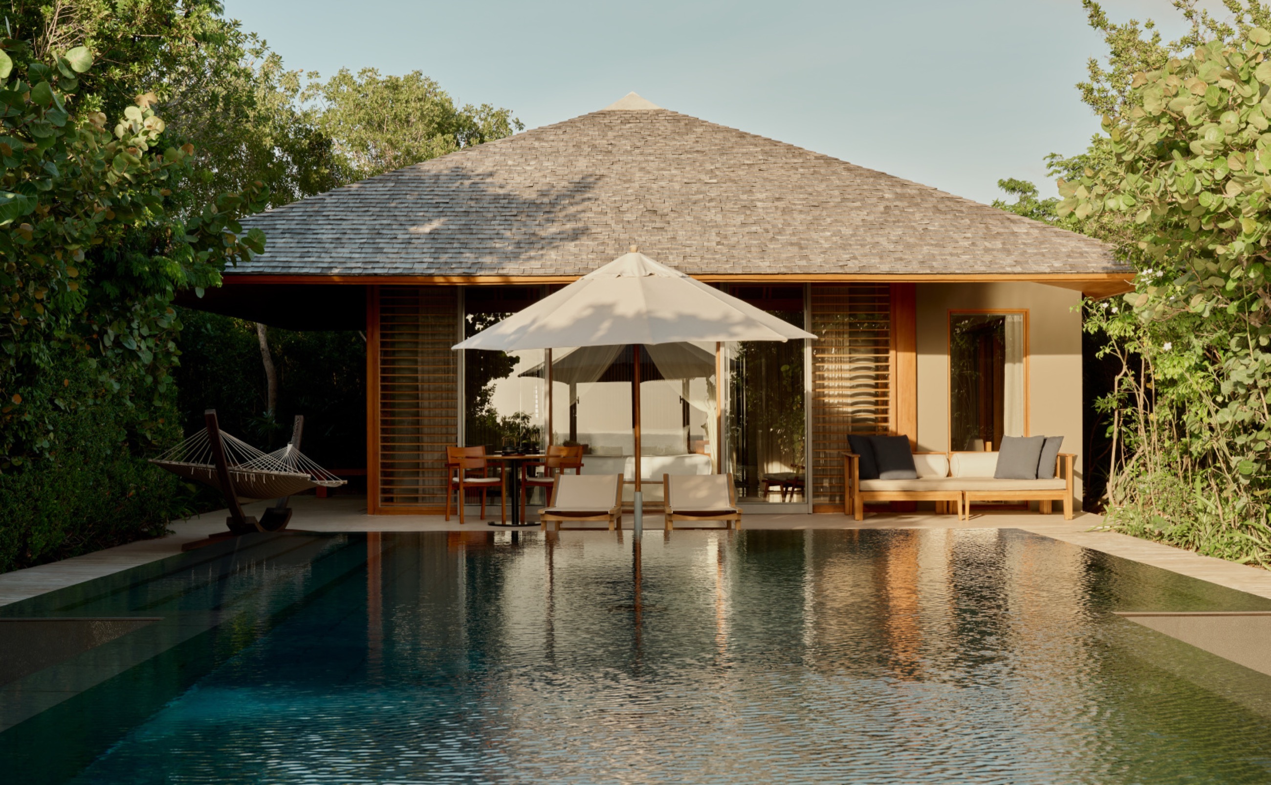 A private pavilion and pool at dusk